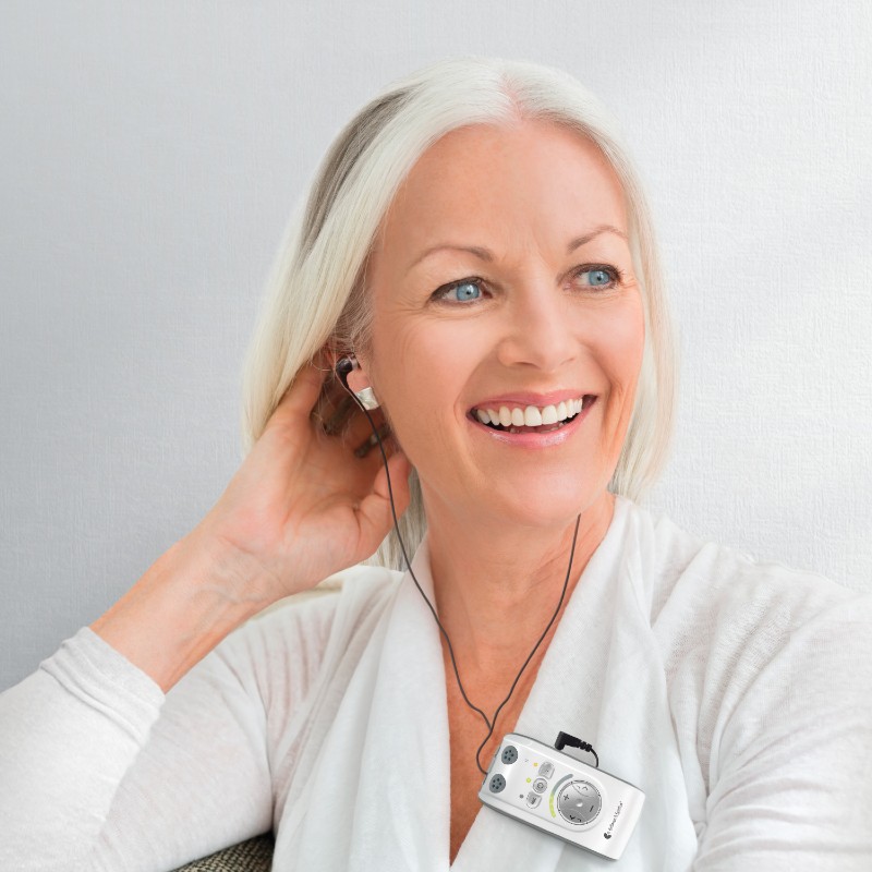 Woman Happily Wearing the Bellman Audio Mino Amplifier